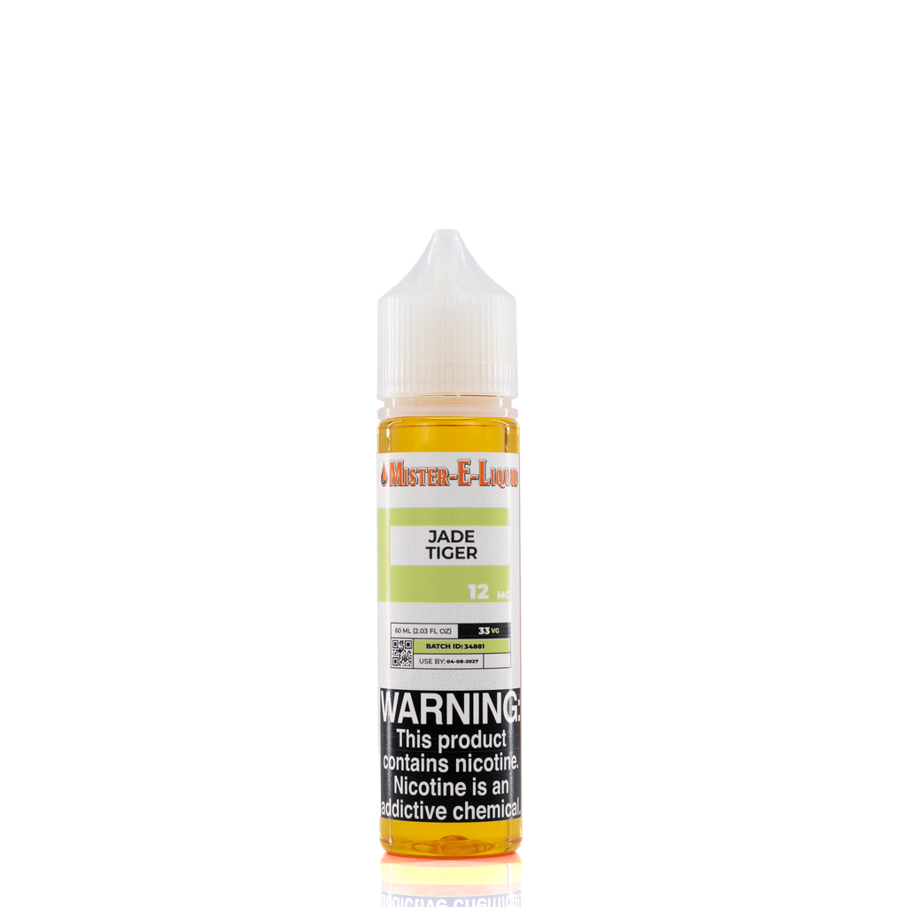 A 12mg mister e-liquid bottle of 'jade tiger' is placed on a reflective surface and against a white background. The label is green, grey, and white.